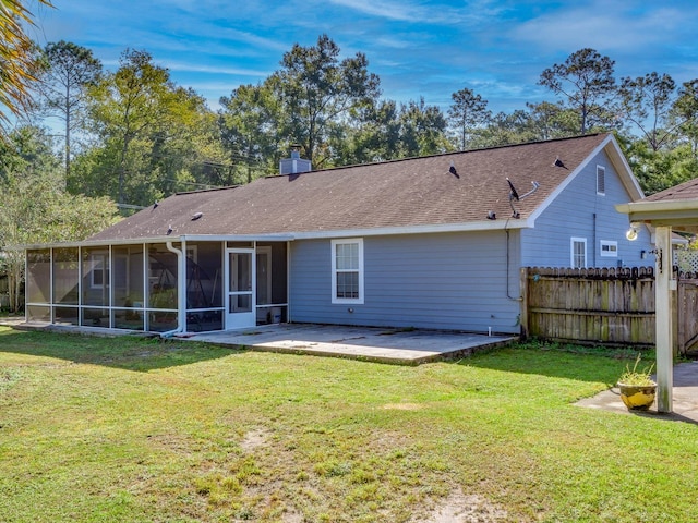 back of property featuring a patio, a sunroom, and a yard