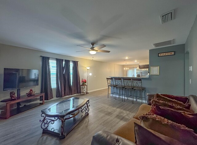 4641 Rivers Landing Way, Tallahassee, FL 32303 - living area featuring ceiling fan, wood finished floors, and a chandelier