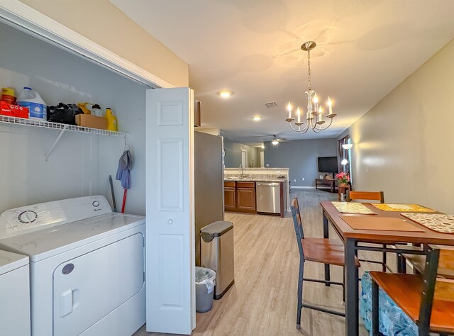 4641 Rivers Landing Way, Tallahassee, FL 32303 - washroom featuring washer and clothes dryer, a chandelier, light wood-style floors, and a ceiling fan