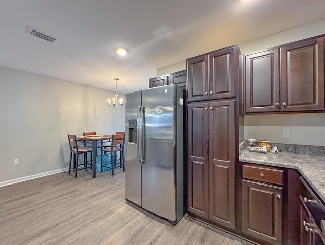 4641 Rivers Landing Way, Tallahassee, FL 32303 - kitchen featuring stainless steel fridge, a chandelier, light wood finished floors, light countertops, and dark brown cabinetry