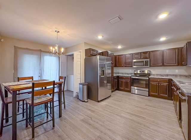4641 Rivers Landing Way, Tallahassee, FL 32303 - kitchen with stainless steel appliances, a chandelier, light wood finished floors, hanging light fixtures, and recessed lighting