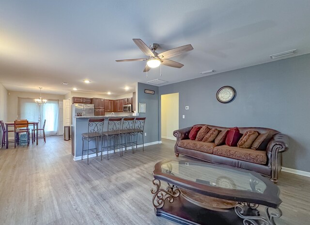 4641 Rivers Landing Way, Tallahassee, FL 32303 - living room featuring a chandelier, light wood finished floors, and ceiling fan
