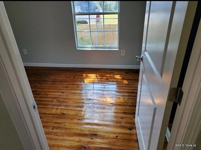 spare room featuring dark hardwood / wood-style floors