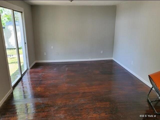 empty room featuring dark hardwood / wood-style flooring and ceiling fan