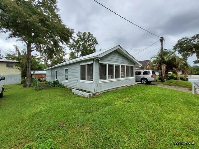 view of side of property with a yard