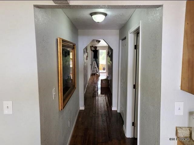 corridor featuring dark hardwood / wood-style floors