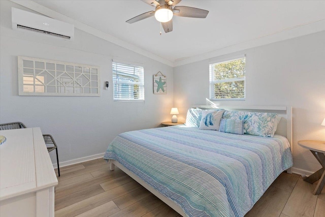 bedroom with lofted ceiling, multiple windows, ceiling fan, and a wall mounted AC