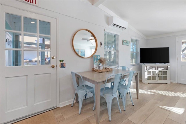 dining area featuring ceiling fan, a wall unit AC, vaulted ceiling, and a wealth of natural light