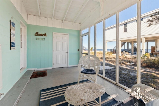 sunroom / solarium with lofted ceiling with beams