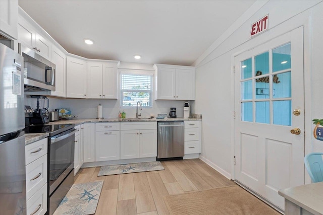 kitchen with sink, stainless steel appliances, light hardwood / wood-style flooring, and white cabinets