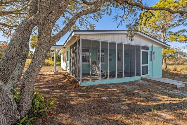 back of house with a sunroom