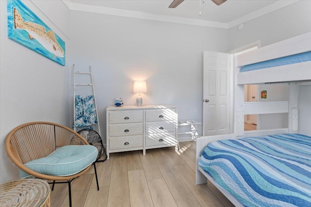 bedroom featuring ceiling fan, ornamental molding, and light hardwood / wood-style flooring