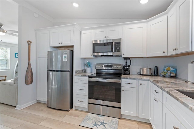 kitchen with stainless steel appliances, ceiling fan, white cabinets, and light stone countertops