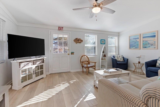 living room featuring ceiling fan, a healthy amount of sunlight, and light hardwood / wood-style flooring