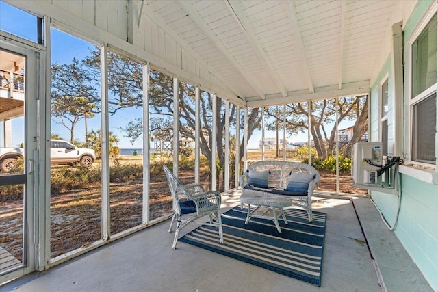 sunroom / solarium with a wealth of natural light and vaulted ceiling with beams