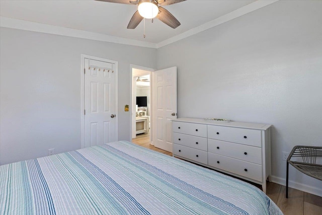 bedroom featuring ceiling fan, light hardwood / wood-style floors, and ornamental molding