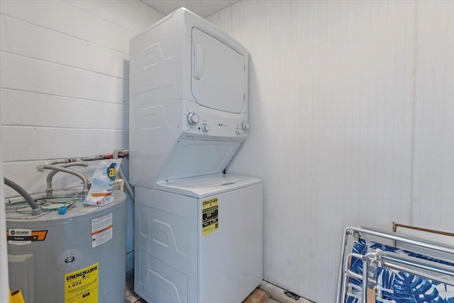 washroom featuring stacked washer and dryer and water heater