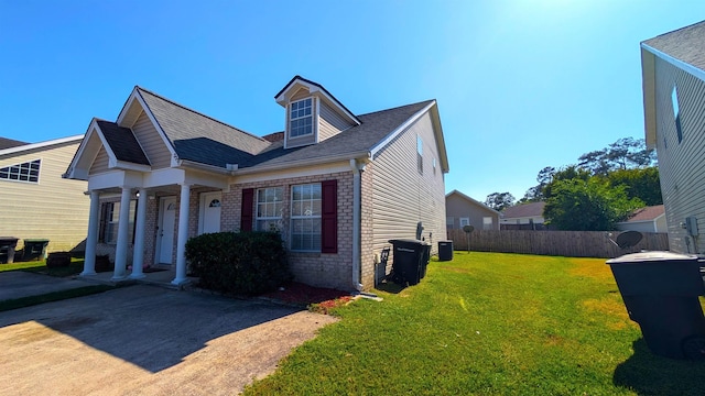 3320 Sugar Berry Way, Tallahassee, FL 32303 - view of front of home featuring fence, a front lawn, brick siding, and roof with shingles