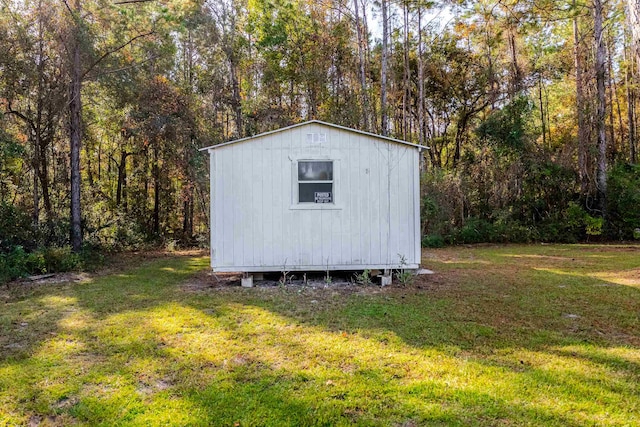 view of outdoor structure featuring a lawn