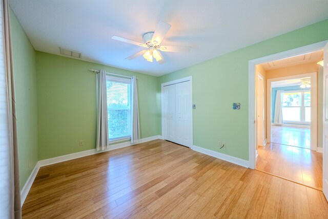 unfurnished room with ceiling fan and light hardwood / wood-style floors