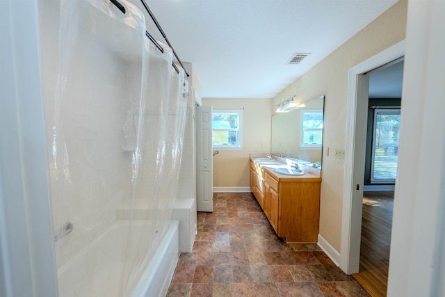 bathroom with shower / bath combo and vanity