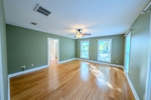 empty room with light wood-type flooring and ceiling fan