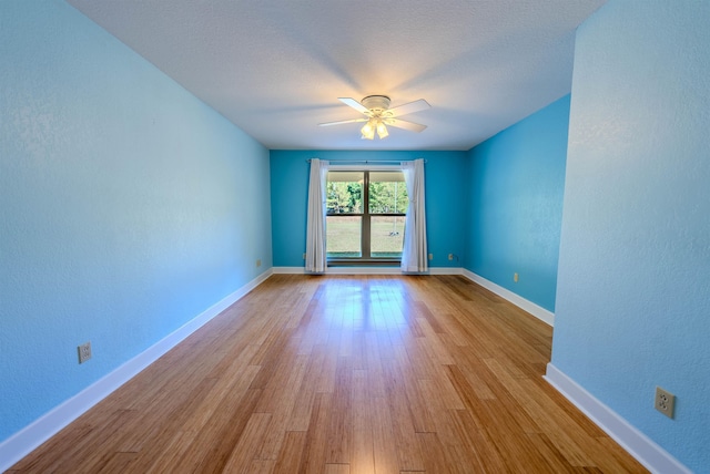 spare room featuring ceiling fan and light hardwood / wood-style flooring