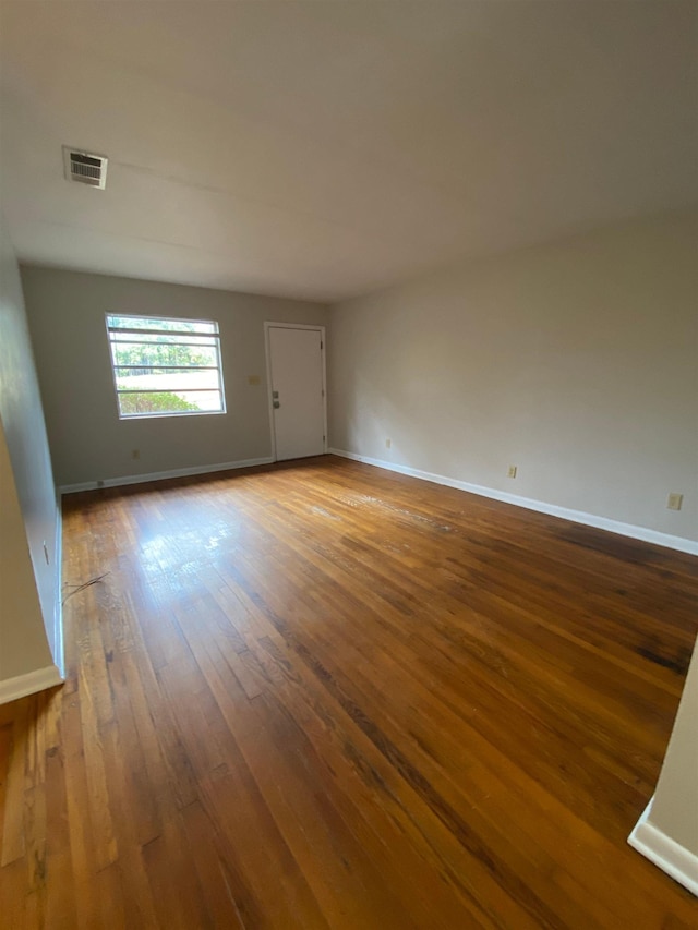 unfurnished room with hardwood / wood-style flooring