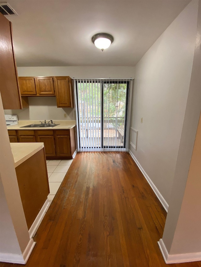 kitchen with sink and light hardwood / wood-style floors