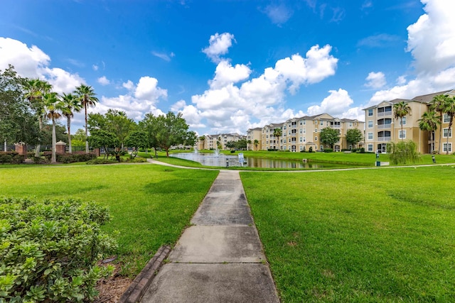 view of home's community with a yard and a water view