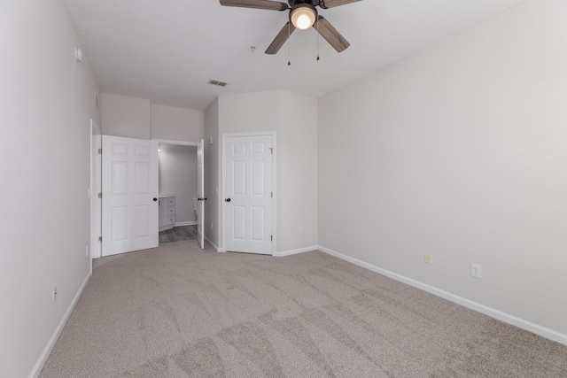 unfurnished bedroom with light colored carpet and ceiling fan