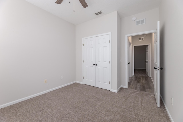 unfurnished bedroom with a closet, carpet, and ceiling fan