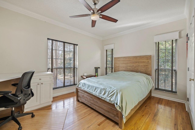 bedroom with ornamental molding, ceiling fan, a textured ceiling, and light wood-type flooring