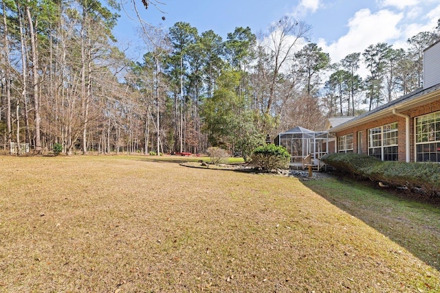 view of yard featuring glass enclosure