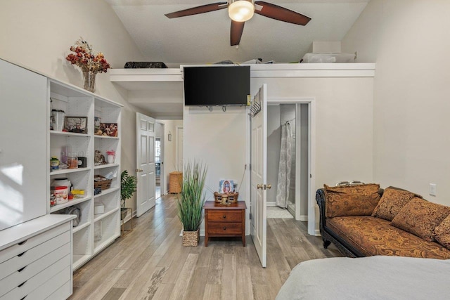 bedroom with vaulted ceiling and light hardwood / wood-style floors