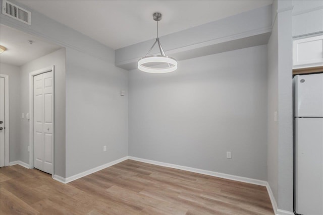 2801 Chancellorsville Dr Unit 1217, Tallahassee, FL 32312 - unfurnished dining area featuring light wood-style flooring and baseboards