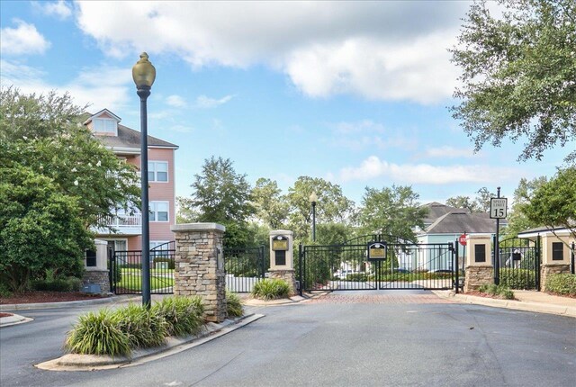 2801 Chancellorsville Dr Unit 1217, Tallahassee, FL 32312 - view of asphalt street featuring a gate, street lighting, curbs, and a gated entry