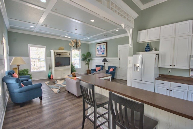 2801 Chancellorsville Dr Unit 1217, Tallahassee, FL 32312 - kitchen featuring white fridge with ice dispenser, open floor plan, dark countertops, dark wood-style floors, and a breakfast bar area