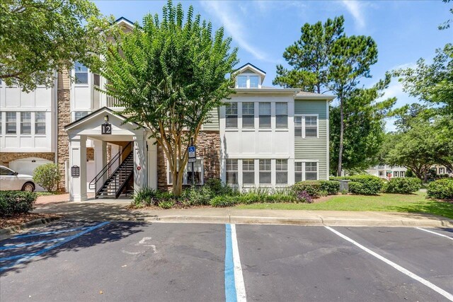 2801 Chancellorsville Dr Unit 1217, Tallahassee, FL 32312 - view of property with stairway and uncovered parking