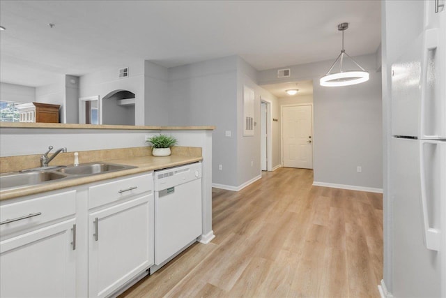 2801 Chancellorsville Dr Unit 1217, Tallahassee, FL 32312 - kitchen featuring white appliances, white cabinetry, light wood-style flooring, light countertops, and pendant lighting