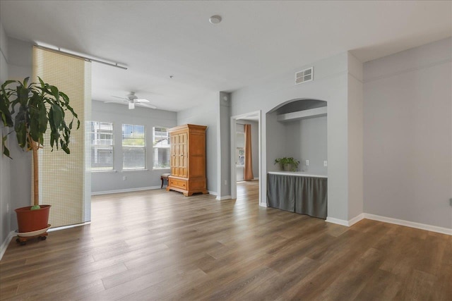 2801 Chancellorsville Dr Unit 1217, Tallahassee, FL 32312 - unfurnished living room featuring arched walkways, wood finished floors, and ceiling fan