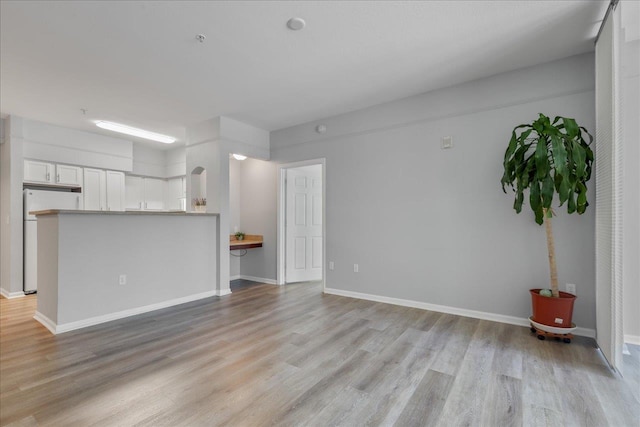2801 Chancellorsville Dr Unit 1217, Tallahassee, FL 32312 - unfurnished living room with light wood-style flooring and baseboards