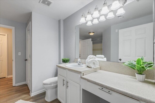 2801 Chancellorsville Dr Unit 1217, Tallahassee, FL 32312 - bathroom with vanity, wood finished floors, and a chandelier