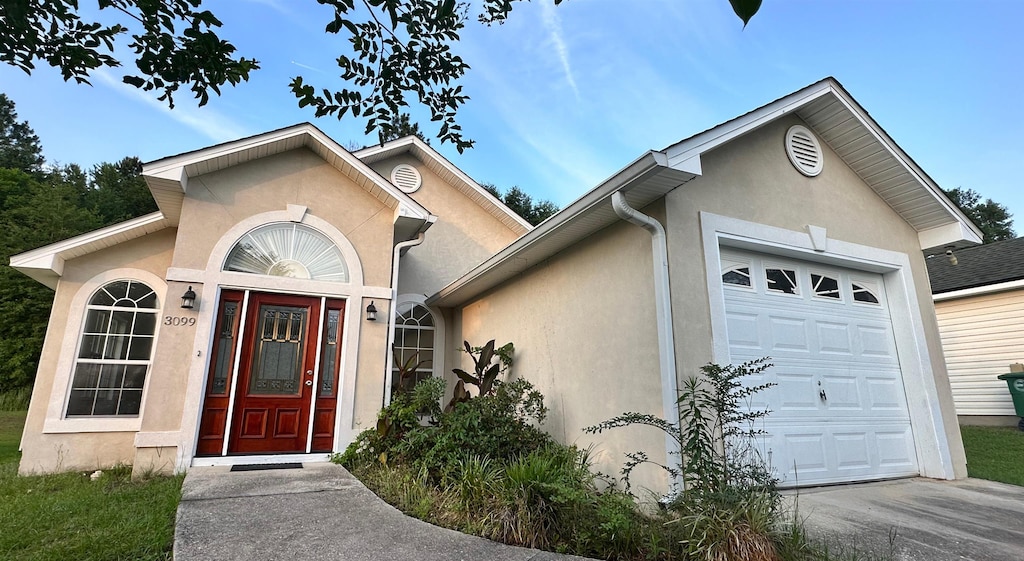 3099 Layla St, Tallahassee, FL 32303 - view of front facade featuring a garage and stucco siding