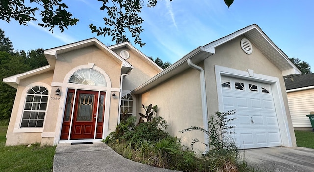 3099 Layla St, Tallahassee, FL 32303 - view of front facade featuring a garage and stucco siding