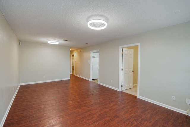 unfurnished room featuring hardwood / wood-style floors and a textured ceiling