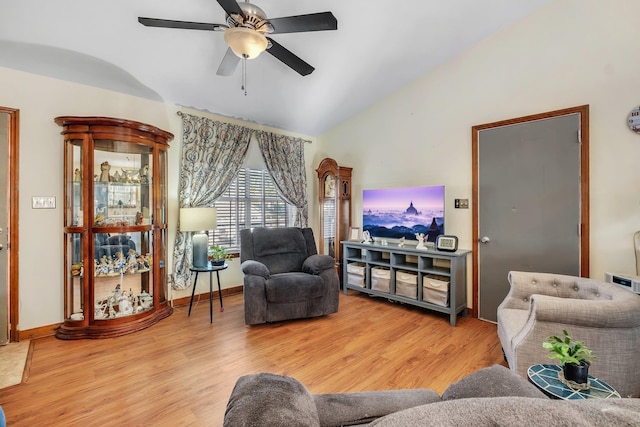 living room with lofted ceiling, ceiling fan, and light hardwood / wood-style flooring