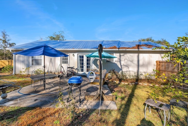 rear view of house featuring a patio and french doors