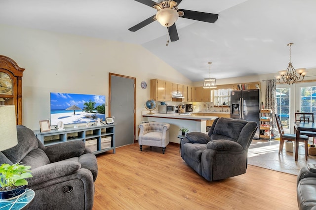 living room with vaulted ceiling, light hardwood / wood-style floors, and ceiling fan with notable chandelier