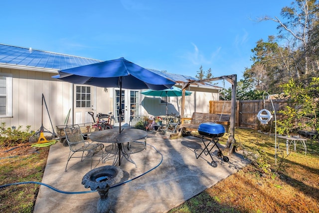 view of patio / terrace featuring grilling area, french doors, and a pergola